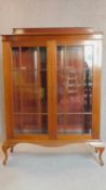 An Edwardian mahogany astragal glazed door bookcase on cabriole supports. 151x106x40cm