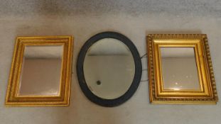 A 19th century gilt framed wall mirror with bevelled plate, another similar and an oval mirror.