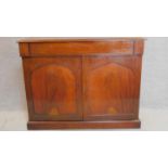 An early 19th century mahogany two door chiffonier fitted frieze drawer above arched panelled doors.