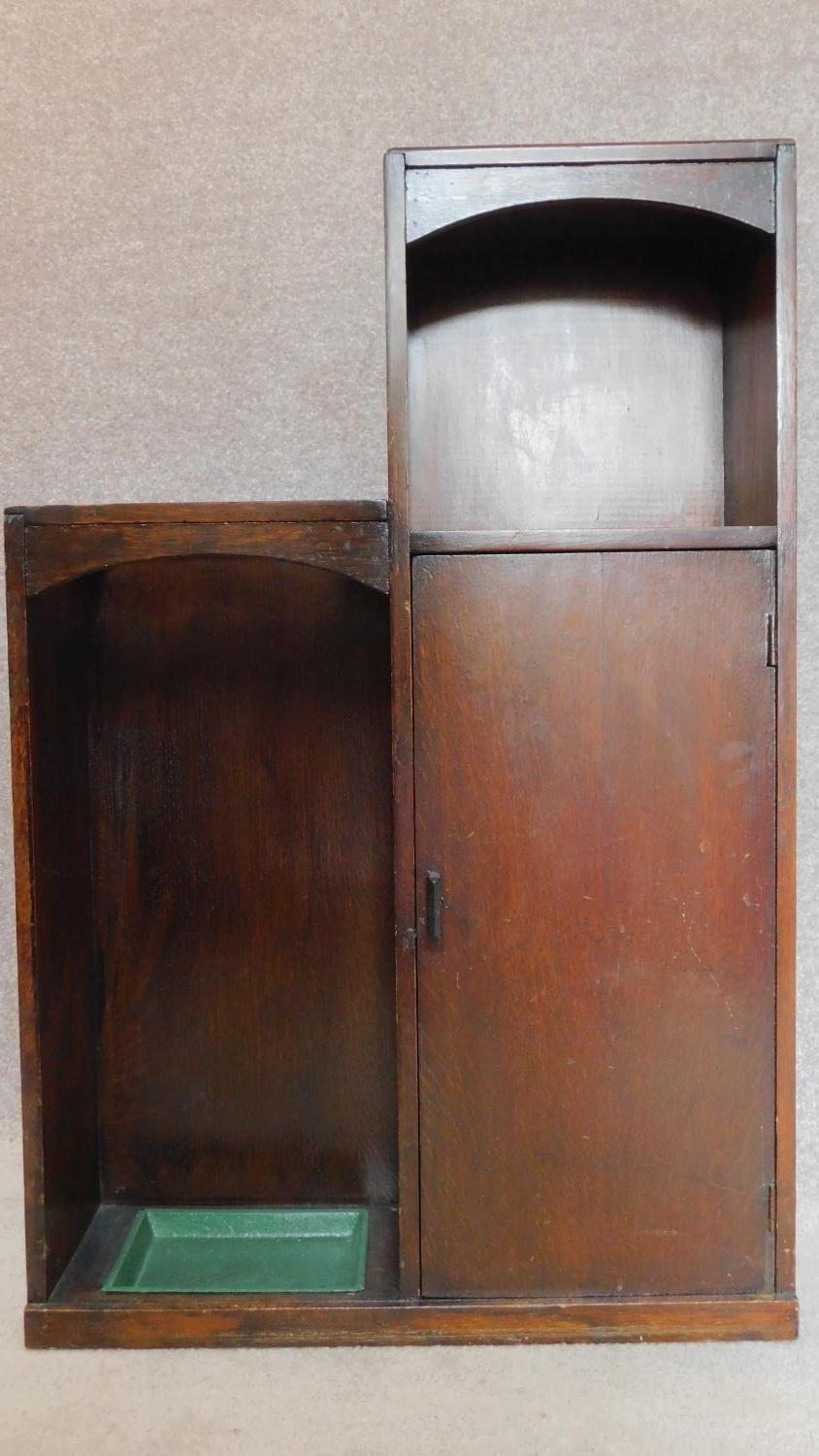 A mid 20th century oak hall cabinet fitted umbrella stand and drip tray. H.93 W.61 D.8cm