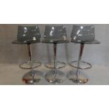 A set of three chrome and smoked perspex high stools. H.98cm (full height)