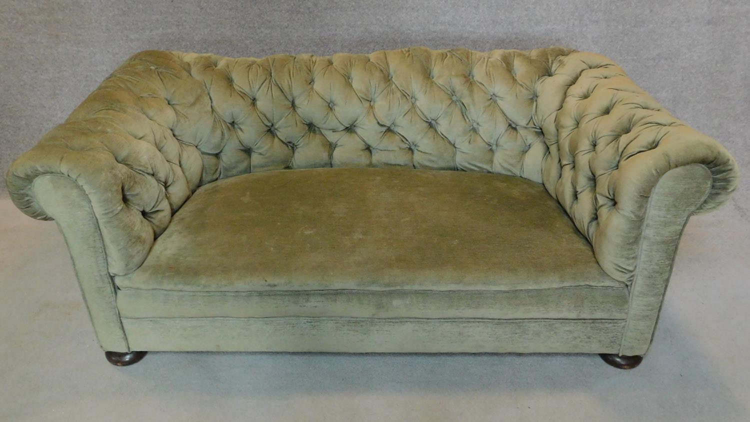 A Victorian buttoned back Chesterfield sofa in green upholstery. H.65 W.180 D.90cm