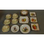 A collection of continental porcelain plates decorated with fruit and a set of vintage floral