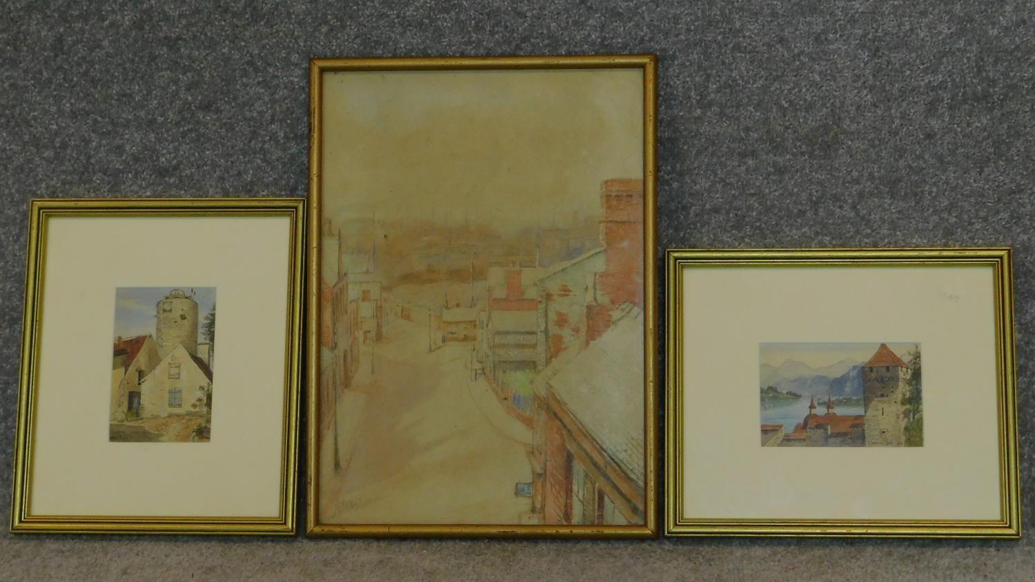 Three framed and glazed watercolours: street scene, a continental castle and farm buildings. 39x29cm