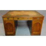 A Victorian oak partners desk with original tooled leather top above frieze drawers and pedestal