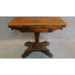 A Regency rosewood foldover top card table with baize lined interior on well carved pedestal and