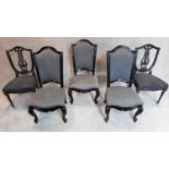 A pair of black lacquered dining chairs and three French style chairs all in the same upholstery.