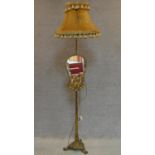 A gilt metal Rococo style standard lamp fitted adjustable glass panel. H.170cm