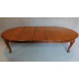 A late Victorian mahogany extending dining table with three extra leaves on cabriole supports. H.