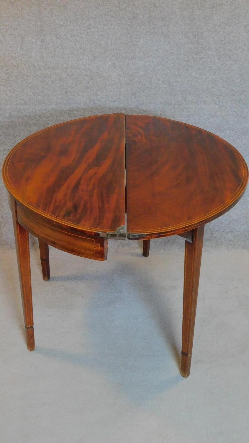 A Georgian mahogany and satinwood strung demi lune foldover top card table on square tapering - Image 4 of 8