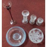 A coloured glass stem vase, a set of graduating candelabras and two glass dishes.