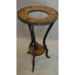 A 19th century ebonised and marquetry inlaid circular stand on triple cabriole supports. H.79cm