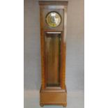 A continental Art Deco longcase clock in oak and burr walnut case with patent label to case. H.204cm