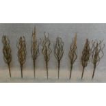 A set of eight decorative wrought metal foliate stands. H.80cm (tallest)