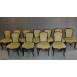 A set of eleven 19th century French style walnut dining chairs on cabriole supports terminated in