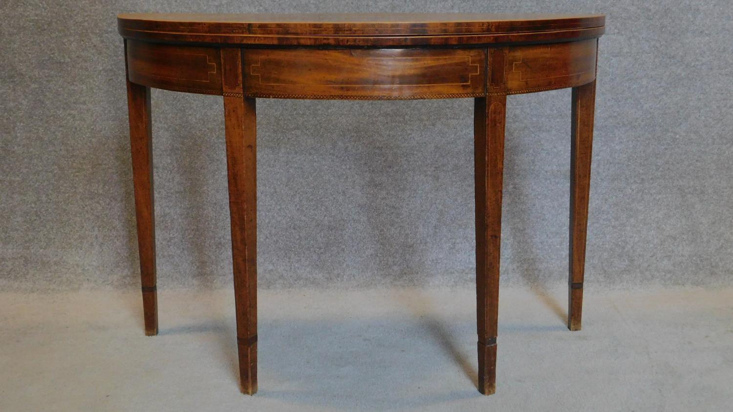 A Georgian mahogany and satinwood strung demi lune foldover top card table on square tapering - Image 2 of 8