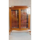 An Edwardian mahogany astragal glazed door bookcase on cabriole supports. 151x106x40cm