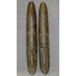 A pair of carved African masks. H.101cm