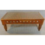 An Eastern carved teak low table with glass inset top. H.46 W.120 D.63cm