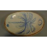 An Art pottery platter glazed and decorated with a palm tree by Michael Cardew. 42x32cm