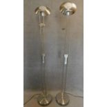 A pair of contemporary chrome spotlights fitted reading lamps. H.182cm