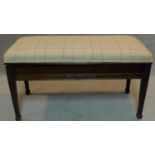 An Edwardian mahogany duet stool with rising top and storage compartment on square tapering