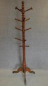 A 19th century turned beech hatstand on tripod base. H.193cm (one peg missing)