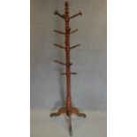 A 19th century turned beech hatstand on tripod base. H.193cm (one peg missing)