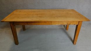 An oak country style planked top refectory table on square tapering supports. H.76 W.193 D.91cm