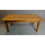 An oak country style planked top refectory table on square tapering supports. H.76 W.193 D.91cm