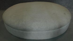 A large oval upholstered ottoman. H.27 W.123 D.95cm