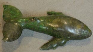 A carved soapstone figure of a whale, inscribed. W.41cm (repair to one dorsal fin)