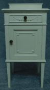 A mid 20th century painted pot cupboard with Adam style swag decoration. H.84 W.41 D.39cm
