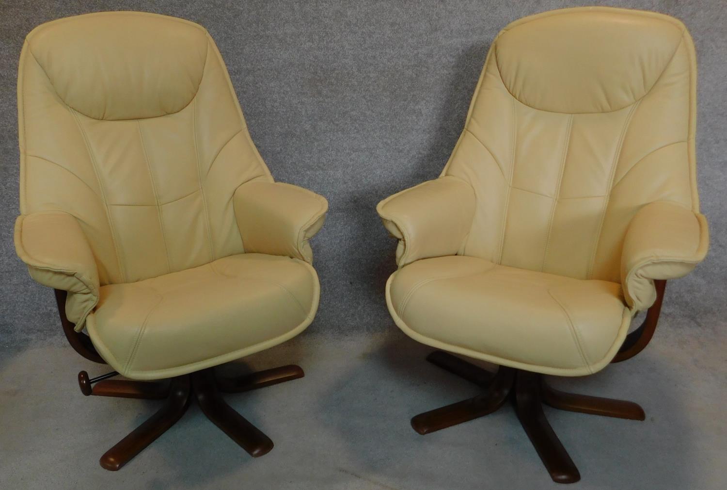 A pair of leather swivelling adjustable reclining armchairs with matching footstools. H.106cm - Image 2 of 6