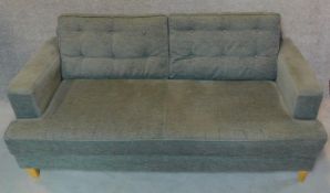 A two seater sofa by Heals (Mistral) in grey buttoned upholstery on tapered block feet. H.85 W.182 D
