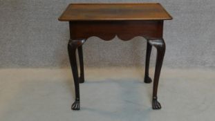 An early 19th century Irish mahogany silver table the lipped rectangular top and shaped frieze on