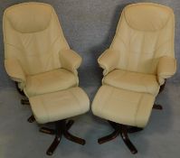 A pair of leather swivelling adjustable reclining armchairs with matching footstools. H.106cm