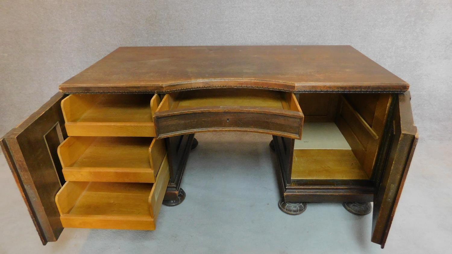 A continental oak and walnut kneehole desk fitted cupboards enclosing slides on reeded bun feet. H. - Image 3 of 7