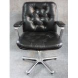 A black leather buttoned back swivel armchair on chrome base. H.91