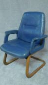 A mid 20th century blue leather upholstered armchair on laminated cantilever base. H.98cm