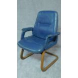 A mid 20th century blue leather upholstered armchair on laminated cantilever base. H.98cm