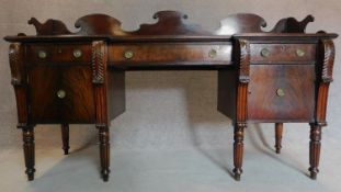 A Regency mahogany sideboard fitted frieze drawers and pair of cupboard doors on spiral tapering