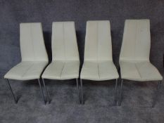 A set of four dining chairs in faux white leather and chrome supports. H.92