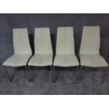 A set of four dining chairs in faux white leather and chrome supports. H.92