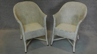 A pair of Lloyd Loom style conservatory tub chairs. H.77cm