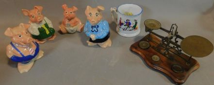 Four Wade pig money boxes, a frog mug and a set of weighing scales. H.17 (tallest)