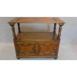 A mid 20th century oak Jacobean style monk's bench with sliding metamorphic back. H.78 W.93 D.46cm