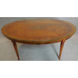 An oval topped handpainted occasional table in the Sheraton style with plate glass top. Signed by