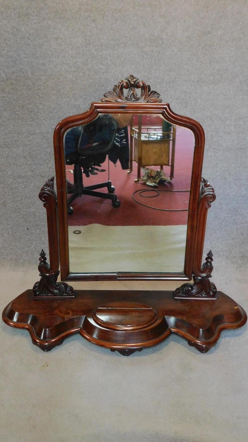 A Victorian mahogany swing toilet mirror on base fitted lidded jewellery box. H.90cm