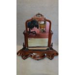 A Victorian mahogany swing toilet mirror on base fitted lidded jewellery box. H.90cm